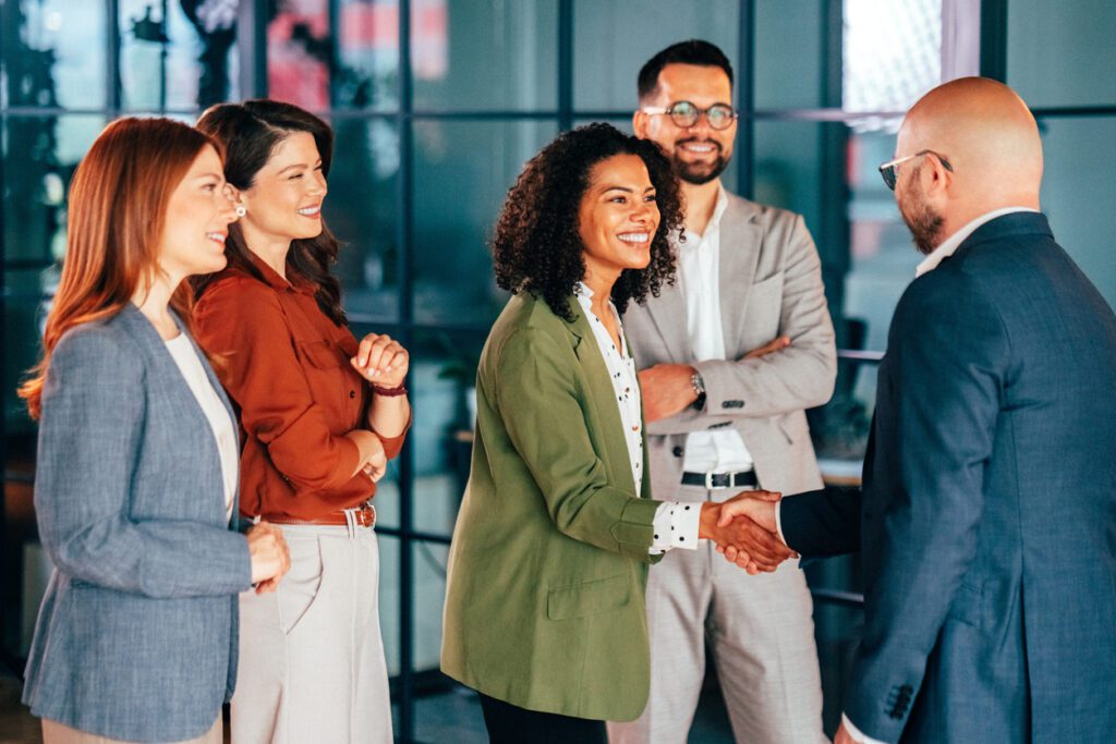 Business professionals shaking hands during a corporate meeting in a modern office
