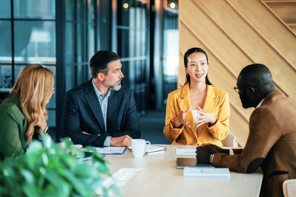 Diverse business professionals engaged in a strategic meeting in a modern office